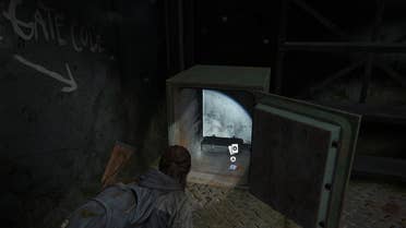 Ellie collecting loot from an open safe after inputting the combination in The Last of Us Part 2 Remastered on PS5